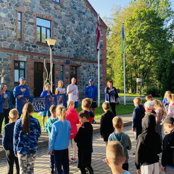 Miera skrējiena dalībnieki un lāpa Sējas skolā - 